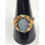 9ct yellow gold ring with large oval panel with opal doublet, AF, edges worn, with floral decorative