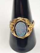 9ct yellow gold ring with large oval panel with opal doublet, AF, edges worn, with floral decorative