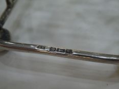 A silver Edwardian toast rack by Lee and Wigfull, Sheffield 1905, on four ball feet. With a silver n