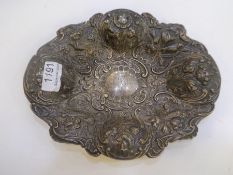 William Comyns and Son. An ornate silver tray having highly embossed decorated design standing in re