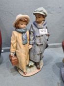 A Lladro gres figure of 2 young children in long coates and hats, 26.5cm