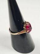 9ct yellow gold dress ring set with large faceted red paste stone, marked 9ct, size N, approx 1.84g