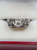 18K white gold diamond dress ring, with central round cut diamond, approx 0.3 carat, with two smalle