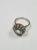 18ct white gold cluster ring with round cut aquamarine surrounded 12 round cut diamonds, aquamarine