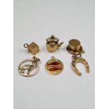 Three 9ct gold charms, a horseshoe, top hat, and kettle, all marked 375, 2.89g approx. A 10K gold pe