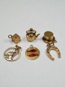 Three 9ct gold charms, a horseshoe, top hat, and kettle, all marked 375, 2.89g approx. A 10K gold pe