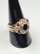 14K yellow gold multi gemstone set dress ring with central oval mixed cut sapphire surrounded diamon