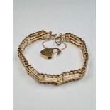 9ct yellow gold 4 bar gatelink bracelet, with heart shaped padlock clasp and safety chain, marked 37