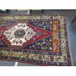 An Anatolian Taspinar woollen rug, having central motif with geometric border, 297 x 162cms