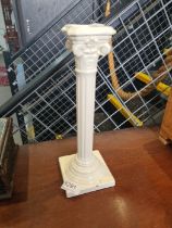 A glazed pottery candlestick of Corinthian column design, possibly Austrian