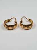Unmarked yellow metal hoop earrings with applied Star decoration, approx 4.76g