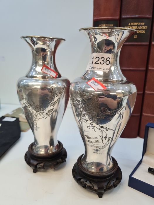 A pair of white metal oriental vases decorated birds, 19cm