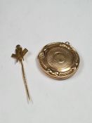 Unmarked yellow metal circular locket of decorative design and yellow metal pin with Masonic motif,