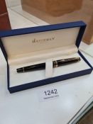 A modern black and gilt Waterman fountain pen in case