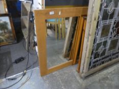 A modern oak oblong wall mirror and two other pine framed mirrors