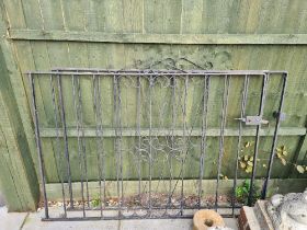 A pair of wrought iron gates, having scroll decoration