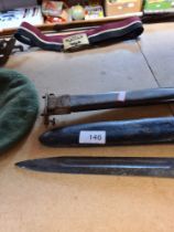 A US Army bayonet (marked UC US) with possibly a World War II era sheath and one other similar sheat