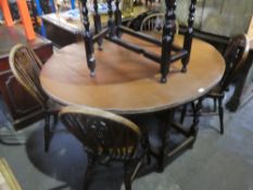 An antique probably late 18th Century, two flap gateleg table and 5 Windsor stickback chairs