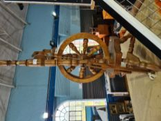 A modern hand made spinning wheel, probably mahogany