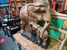A large wooden carving of elephant and calf having gilt decoration, approx 59cm long x 61cm tall.