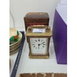 A small brass carriage clock in fitted box