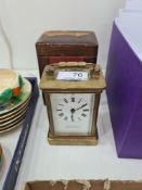 A small brass carriage clock in fitted box