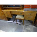 A 1980s chest of drawers with matching dressing table with stool