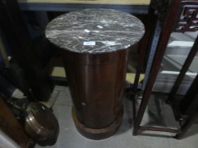 An antique cylindrical bedside cupboard with damaged marble top