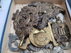 Two Victorian military helmet badges, a Scots guards two piece belt buckle and other metal cap badge