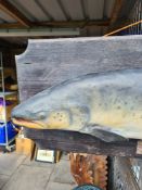 A hanging model of Salmon, possibly fibreglass, on a wooden plaque