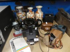 A selection of vintage cameras including Polaroid, Halina, a teapot and three oriental vases and a m