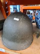 An American military M1 helmet (no liner) and Bazooka carrier