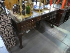 A reproduction mahogany writing desk having 5 drawers on carved Cabriole legs, 160cm