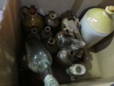 A selection of stoneware bottles and flagons and a ship in a bottle