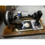 One Singer and one Frister & Rossmann cased sewing machines