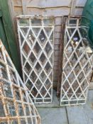 A quantity of antique iron window frames having lattice decoration, and others