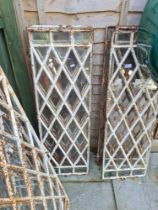 A quantity of antique iron window frames having lattice decoration, and others
