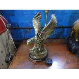 A brass table lamp with eagle sculpture