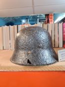 A German World War II MK42 helmet, excavated from the Eastern Front, and a relic 3" rocket from Worl