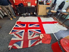 A large Royal Navy ensign with military markings, 177cm x 353cm and two smaller examples