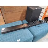 An LG sound bar with Sub Woofer and remote