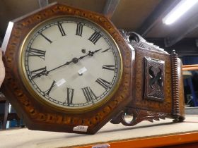 A wooden wall clock with overpainted dial