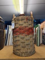 An old stoneware Pusser's Rum one gallon jar, with two handled Wicker outer