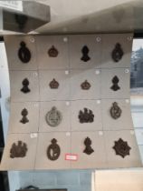 A quantity of World War II economy cap badges made from plastic with metal fittings, some marked Sta