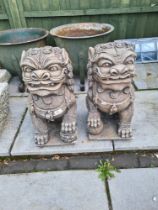 A pair of reconstituted garden figures of Chinese dogs