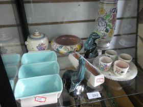 A shelf of Poole Pottery items