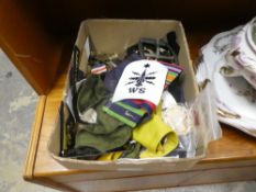 A box of military cap badges, etc