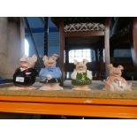 A nice collection of four Nat West piggies, with their original stoppers