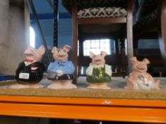 A nice collection of four Nat West piggies, with their original stoppers