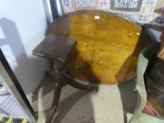An antique and inlaid loo table on later reproduction tripod base